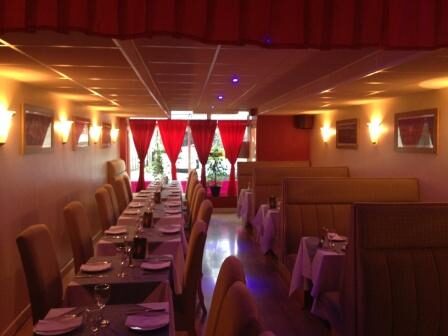 Tables laid with white cloths and folded napkins