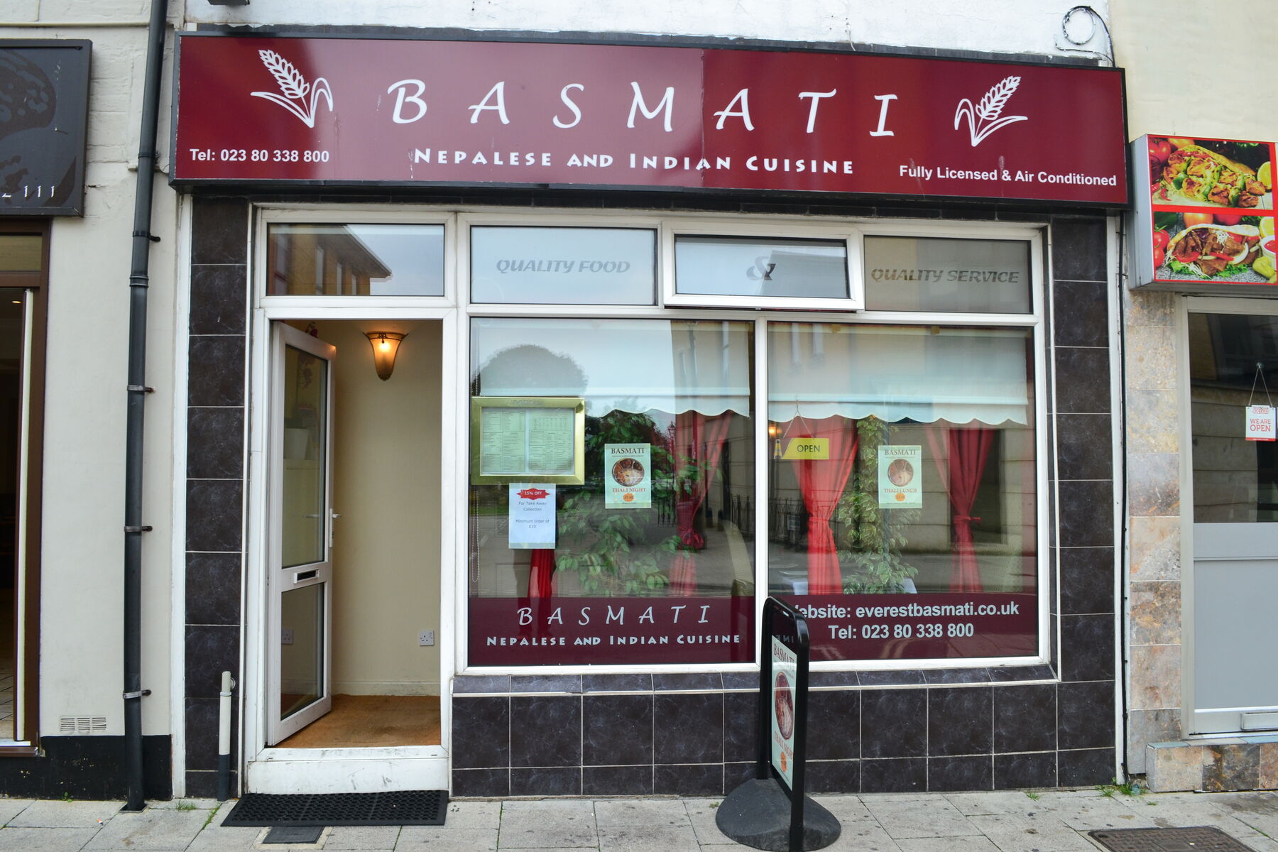The Basmati shopfront on Bedford Place, with its maroon and gold sign